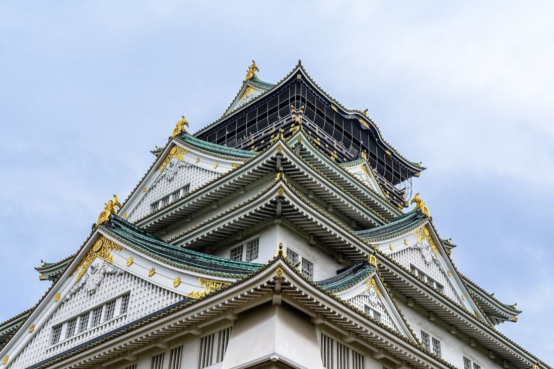 The keep of Osaka Castle above its stone walls and moat