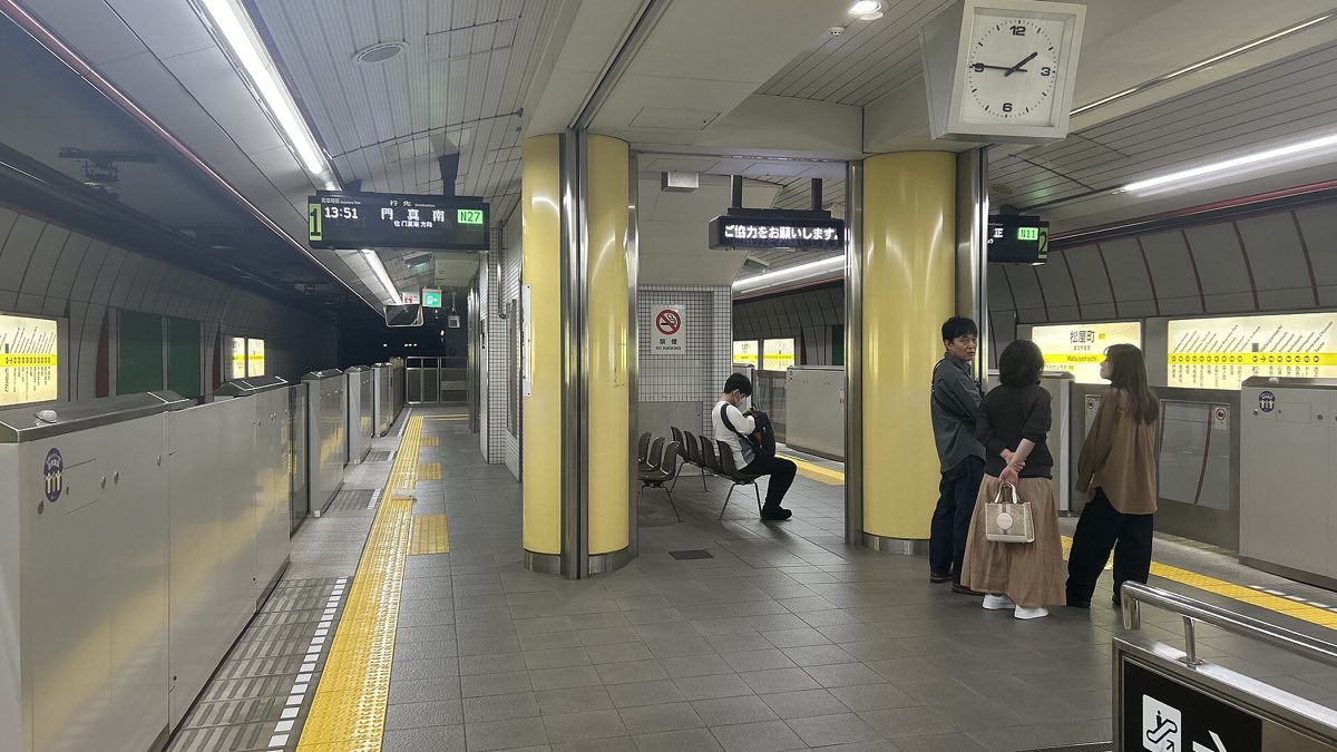 Travellers on a platform at Osaka Station